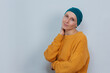 Confident looking young woman in hat challenging serious illness