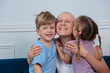 Two kids hug their mother without hair encourage to fight cancer