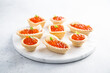 Red caviar served in tartlets