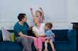 Loving family with kids hugging mother cancer survivor on sofa