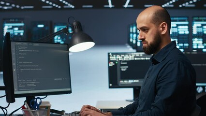 IT engineer overseeing server room, running code on computer, troubleshooting servers. Programmer at work upgrading hardware clusters, networking systems and storage arrays