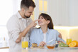 © New Africa - Happy couple spending time together during breakfast at home