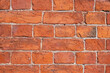 Fragment of an old red brick wall in a light tone