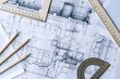 © uladzimirzuyeu - Architectural engineering design plan drawing on the table. Architect's work on table in studio. Construction design and plan