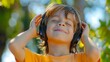 Young Boy Listening to Music With Headphones and Smiling