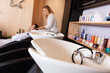 view of sinks and hairdresser washing clients hair in salon