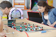 competitive friends playing table football
