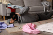 © Pixel-Shot - Scared male thief lying on floor in room at night
