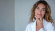 © Wendy2001 - Hotel relax zone gorgeous mature woman skincare before of after wellness spa procedures with a happy smile wearing bathrobe at spa salon looking at camera