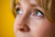Close Up Portrait Of Woman With Nose Piercing Against Yellow Studio Background