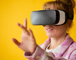 Woman Exploring Wearing Virtual Reality Headset Against Yellow Studio Background