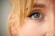 Close Up Studio Shot Of Woman's Eye Looking At Camera Against Plain Studio Background