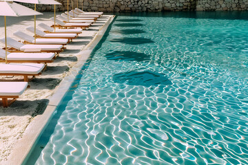 Wall Mural - Swimming pool and sun loungers at stylish tropical spa hotel, summertime banner mockup. Summer travel sales and vacation concept.