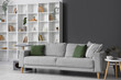 © Pixel-Shot - Interior of living room with grey sofa and bookshelf