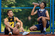 Basketball players playing together drinking water on summer playground