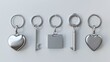 © Mark - Silver colored accessories or souvenir pendant mock up. Modern 3d illustration, icon. Set of metal round, rectangular and heart shape keychain holders on white background.