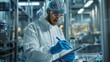© Fleuronica - A man in a lab coat concentrates as he writes on a clipboard in a laboratory setting