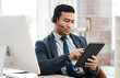 © peopleimages.com - Man, agent and call centre or working with tablet, crm and telemarketing with sales consultant. Support, help desk and employee with headset for online communication job, searching faq on internet
