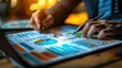 © เลิศลักษณ์ ทิพชัย - Close-up of a businessman's hand holding a pen and meticulously analyzing a marketing strategy with calculations on charts and graphs showing the growth of financial investment results.