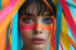© Femmes.Digital - Fashion model with ribbons wrapped around her face, highlighting vibrant makeup and striking blue eyes. A colorful, high-fashion portrait that plays with color and bold design.