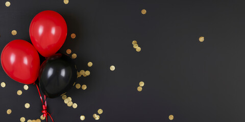 Balloons on a black background and confetti