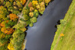 A drone view of the lake in the woods. An aerial view of an autumn forest. Pond among the trees. Top view. Thuringia, Germany.