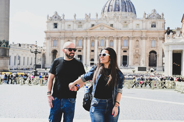 Wall Mural - Happy smiling beautiful  Tourists  couple traveling at Rome, Italy, poses and making photos  in front of   Vatican City  at, Rome, Italy.Concept of Italian gastronomy and travel. Italian couple having