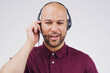 Man, thinking and studio with headphones for customer service or call center, smile for communication. Male person, white background and microphone with happiness for chat, telemarketing or working