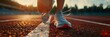 © KumCup - Close up of a woman runner lacing her shoes on the track in the morning, with space for copy text and a closeup shot