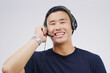 Headset, asian man and smile in call center in portrait on white background with telemarketing or crm. Customer support, help and technology with voip for contact on internet with telemarketer