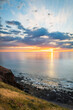 Dramatic sunset with fishing boat viewed from Hallett Cove Beach, South Australia