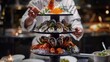A chef presenting a gourmet seafood tower with oysters, lobster, and caviar