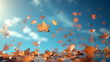 Autumn maple leaves flying against the background of  bright blue sky