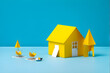 yellow paper house on a vibrant blue background