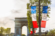 French flags and Arc de Triomphe in Paris