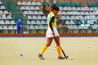 Young female field hockey player warming up before the game