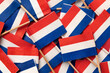 Miniature Dutch paper flags close up full frame as background  