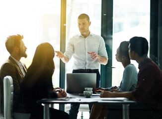 Poster - Businessman, coach and presentation with laptop in meeting for collaboration, ideas or training staff at office. Man or employee talking to group of employees in brainstorming discussion at workplace