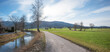 walkway along Jenbach river, view to Auer Weitmoos landscape, near Bad Feilnbach
