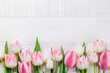 Pastel colorful tulips grace the table, providing a serene and vibrant backdrop