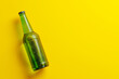 Beer bottle on yellow background