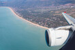 Airplane flying over beach of Gava as seen through window of an aircraft - Barcelona, Spain