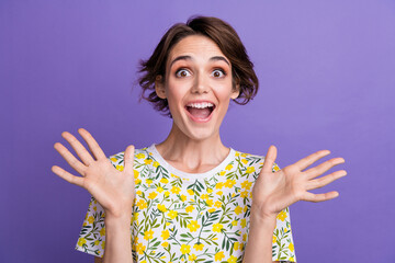 Poster - Photo of pretty young woman raise arms open mouth wear t-shirt isolated on violet color background