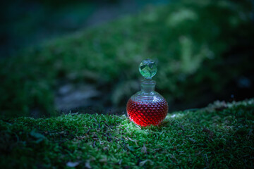 magican potion in glass bottle in summer forest