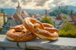 Salty German pretzel pastry outdoors with a Bavarian town in the background