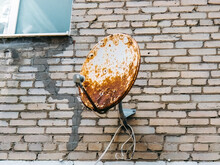 Rusty Satellite Dish On The Wall