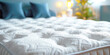 © Katerina Bond - Soft and comfortable white orthopedic mattress on the bed in the bedroom, close-up. Selective focus.