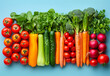 Fresh vegetables arranged in rainbow pattern on blue background