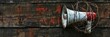 A white and red colour megaphone wrapped in barbed wire on rust metal background