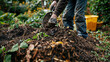Person turning compost pile in lush community garden